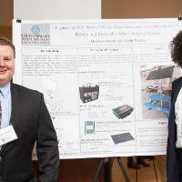 Electrical and computer engineering graduate students, Matthew Burns (left) and Jayla Wesley (right), standing in front of their poster.